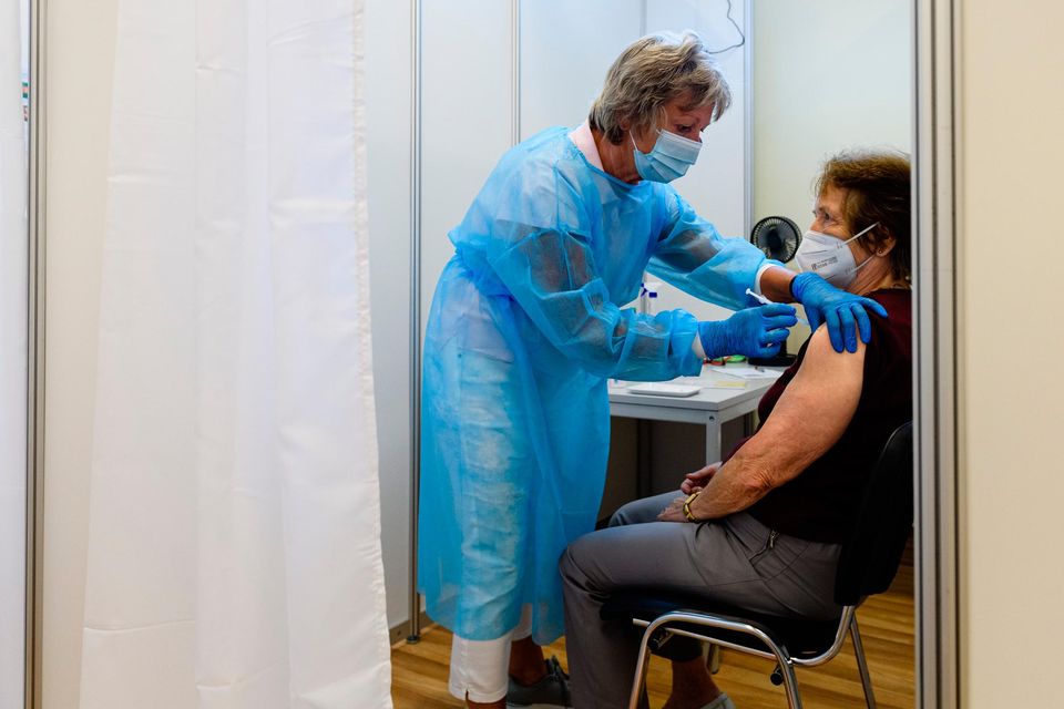 Medical staff member inoculates an elderly patient with a booster inoculation of the Pfizer/BioNTech vaccine against Covid-19 on September 15, 2021 in Erfurt, Germany. Booster vaccinations, which are an additional vaccination shot given to strengthen an existing full vaccination, are underway across Germany for elderly patients who were among the first to receive shots in the initial vaccine rollout. (Photo by Jens Schlueter/Getty Images)