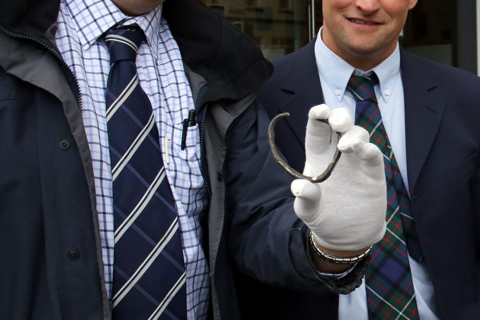 David Taylor (left) with his brother in-law Andrew Coulter, from Kircubbin, Co Down, with the rare Viking silver ring he discovered on his brother in-law's farm, outside a special treasure trove inquest hearing at Belfast coroner's court.
