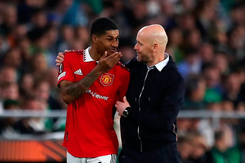 Erik ten Hag, manager of Manchester United, speaks with his player Marcus Rashford