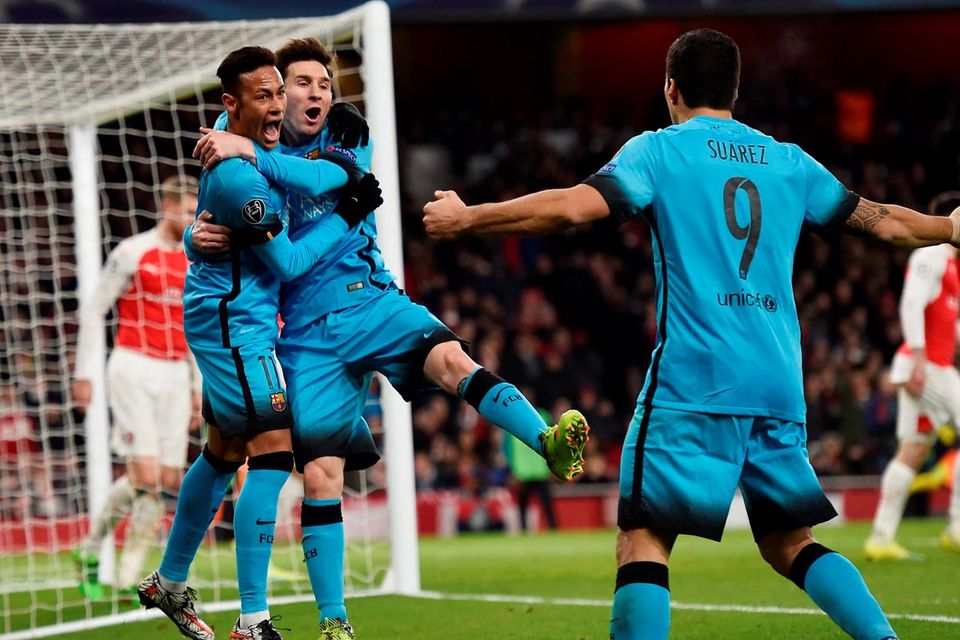 Lionel Messi celebrates with Neymar and Luis Suarez after scoring the first goal against Arsenal last February
