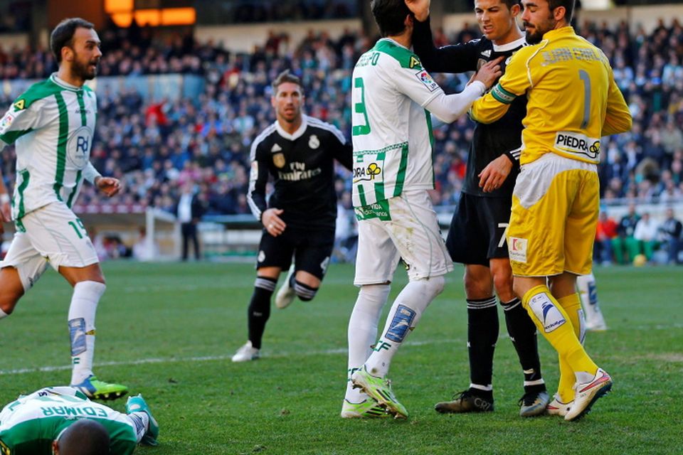 Real Madrid's Cristiano Ronaldo (2nd R) reacts as Cordoba's Edimar Fraga (bottom) lies on the pitch during their Spanish First Division soccer match at El Arcangel stadium in Cordoba