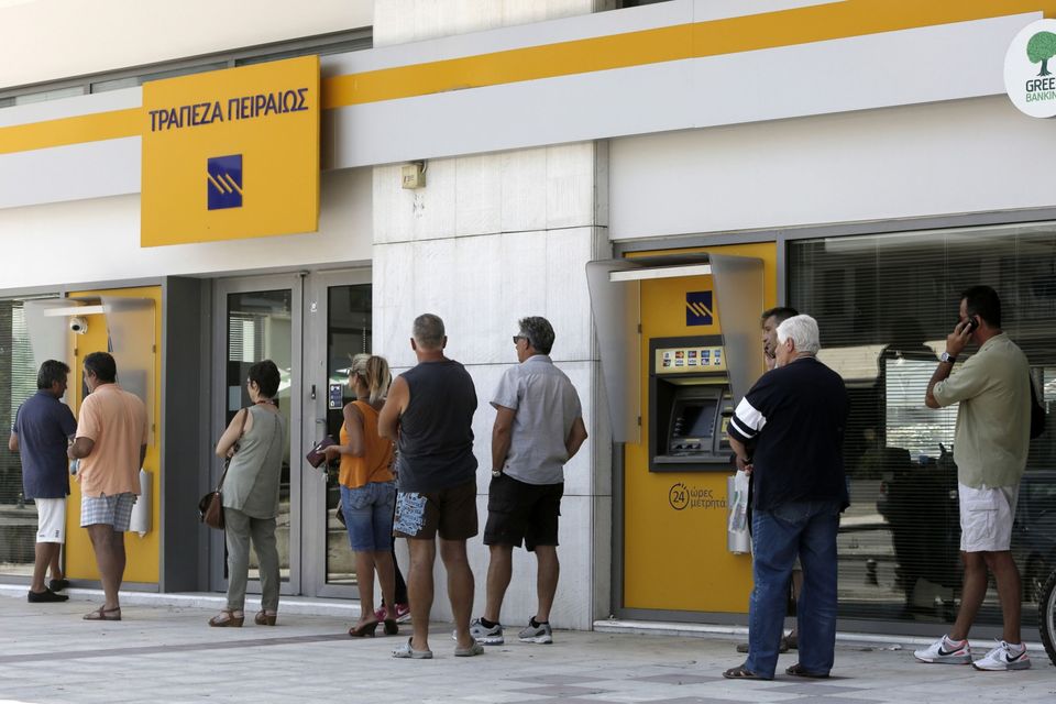 Loans: Customers queue outside a Piraeus Bank branch in Thessaloniki, Greece. Photo: Konstantinos Tsakalidis/Bloomberg