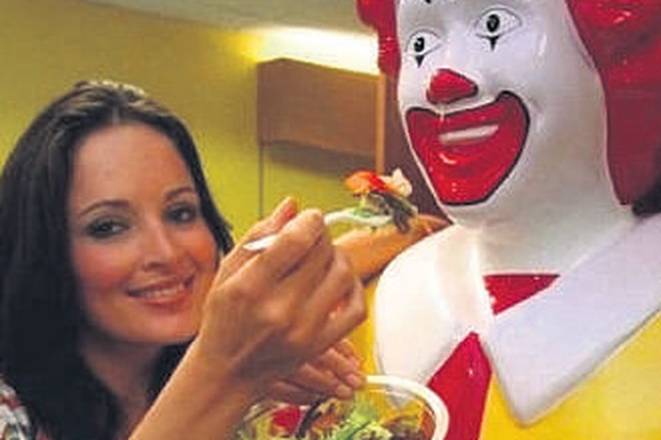 Model Andrea Roche shares a salad with Ronald McDonald