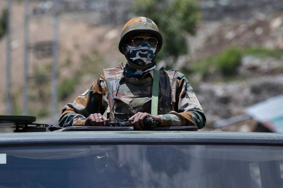 An Indian soldier sits atop an army vehicle during border tensions between China and India in 2020. Photo: AP