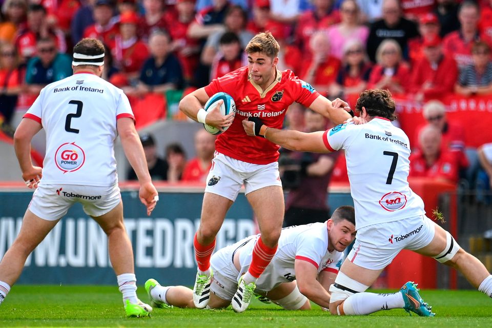 Jack Crowley of Munster is tackled by David McCann of Ulster, right, during the United Rugby Championship match at Thomond Park in Limerick. Photo: Seb Daly/Sportsfile