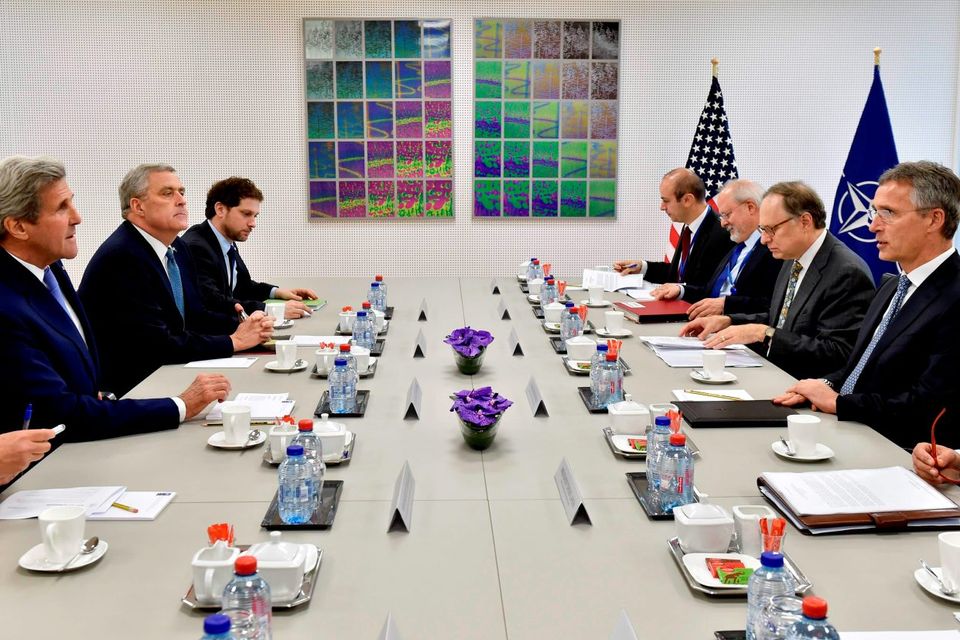 US Secretary of State John Kerry (L) and members of his delegation take their places at the table opposite NATO Secretary General Jens Stoltenberg (R) and his delegation ahead of a meeting at the NATO headquarters in Brussels. Getty Images
