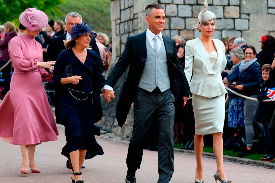 Gwen Field, Robbie Williams and Ayda Field arrive ahead of the wedding of Princess Eugenie to Jack Brooksbank at St George's Chapel in Windsor Castle