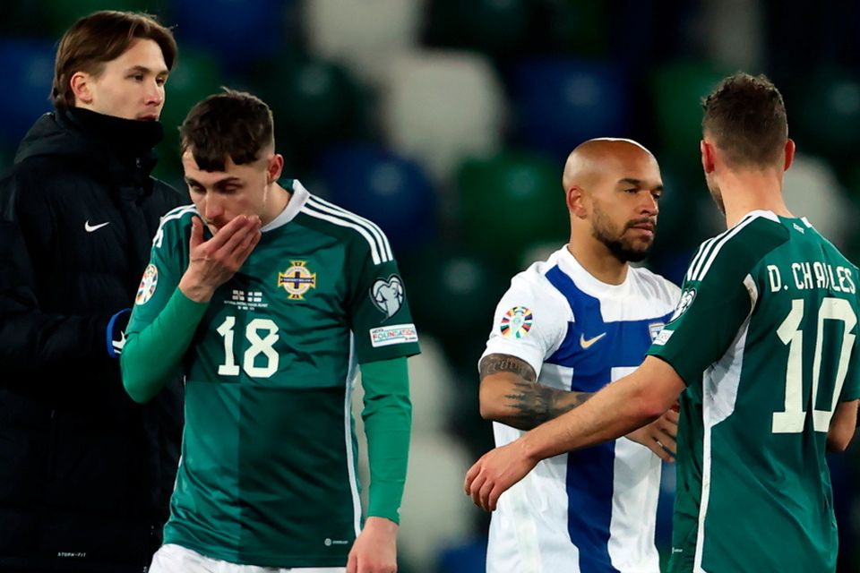 Northern Ireland's Gavin Whyte and Dion Charles react following defeat