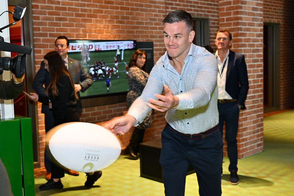 Jonathan Sexton tests his passing skills at the opening of the International Rugby Experience in Limerick.