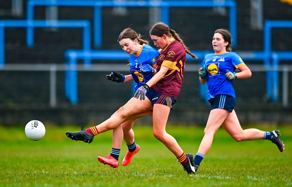 28 March 2023; Lauren Woods of Loreto St Michael's scores her side's third goal despite the attention of Eimear Geraghty of Sacred Heart during the Lidl All Ireland Post Primary School Senior ‘A’ Championship Final match between Sacred Heart School in Westport, Mayo, and Loreto St Michael’s in Navan, Meath, at Glennon Brothers Pearse Park in Longford. Photo by Ben McShane/Sportsfile