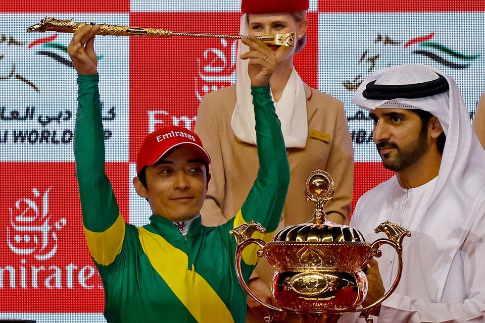 Yuga Kawada celebrates on the podium after winning the Dubai World Cup on Ushba Tesoro at Meydan Racecourse, Dubai