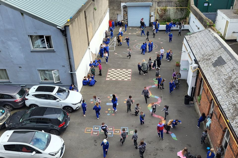 Children at Gaelscoil Choláiste Mhuire use a shared car park as their playground