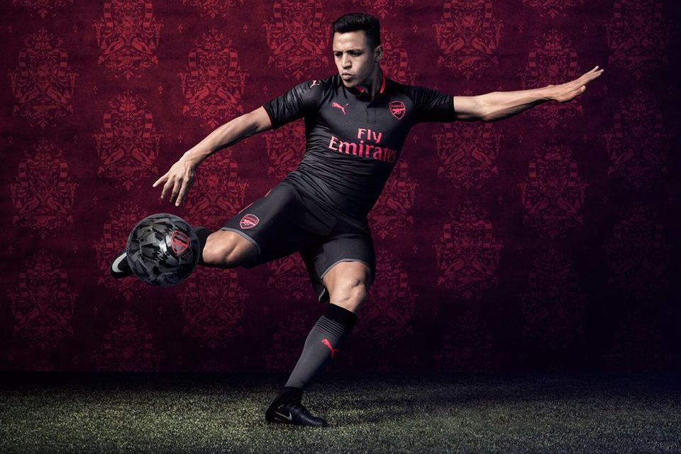 Alexis Sanchez models Arsenal's new jet black kit. CREDIT: PUMA