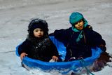 thumbnail: Tyanna Darcy, 2, left, and Sandrio Jiqia, 4, enjoy playing in the snow. Lanesborough, Finglas, Dublin. Picture: Caroline Quinn