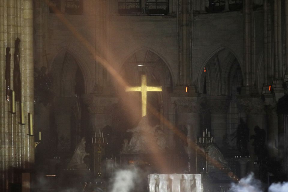 Smoke is seen around the altar inside the building (AP)