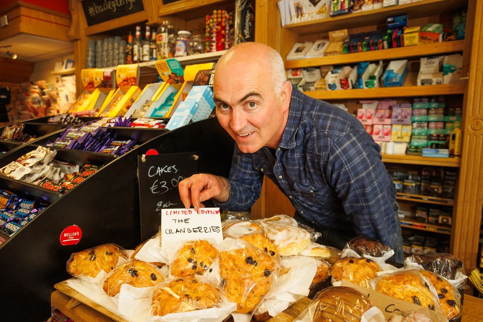 Colm Heneghan shows off the scones in honour of The Cranberries who filmed outside the shop. Pic: Mark Condren