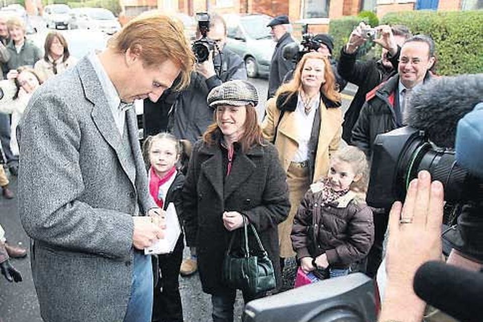 Hollywood actor Liam Neeson signs autographs
outside the Lyric Theatre in Belfast, where he started his career and which closed at the weekend for renovations.