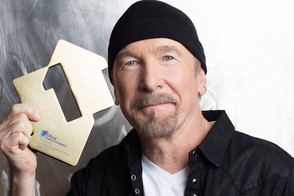 U2’s The Edge poses with his Official Number 1 Album Award for Songs Of Surrender from the Official Charts Company (Emily Quinn)