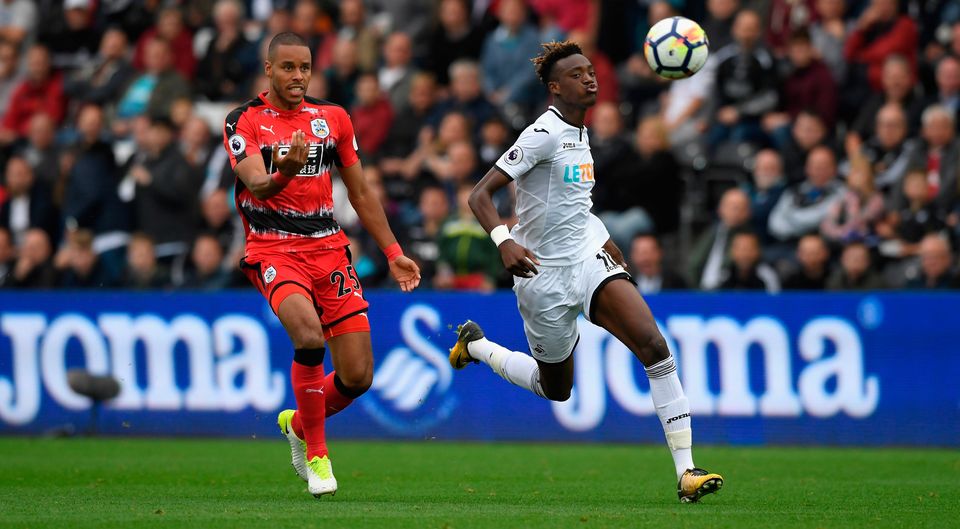 Swansea striker Tammy Abraham (r) races to a loose ball with Zanka. Photo: Getty Images