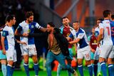 thumbnail: Charlie Mulgrew of Blackburn grabs a Blackburn fan after he runs on the pitch during the Carabao Cup Second Round match between Blackburn Rovers and Burnley at Ewood Park on August 23, 2017 in Blackburn, England. (Photo by Nathan Stirk/Getty Images)