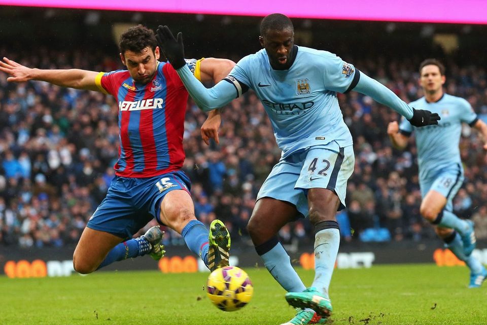 Yaya Toure scores Manchester City's third goal past the despairing tackle of Crystal Palace captain Mile Jedinak during their Premier League clash at the Etihad. Photo: Alex Livesey/Getty Images