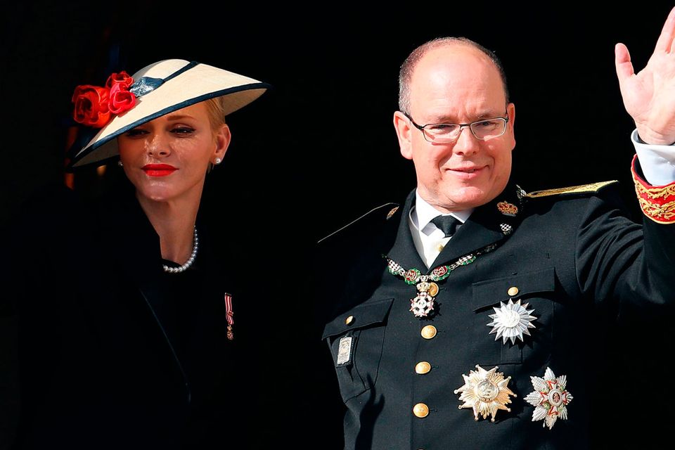Prince Albert II of Monaco (R) and Princess Charlene of Monaco (L) appear on the balcony of the Monaco Palace during the celebrations marking Monaco's National Day