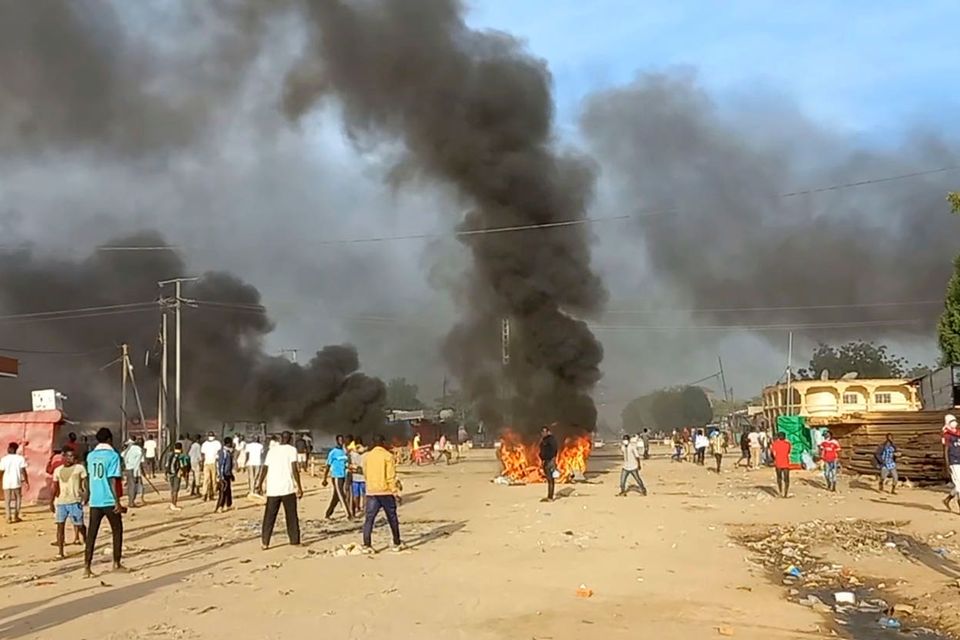 Anti-government demonstrators set a barricade on fire during clashes in N’Djamena (PA)