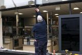 thumbnail: A workman outside the Aldi store in Rathmines after an incident in which a car smashed the window. Photo: Collins