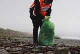 thumbnail: Collecting rubbish on the beach.