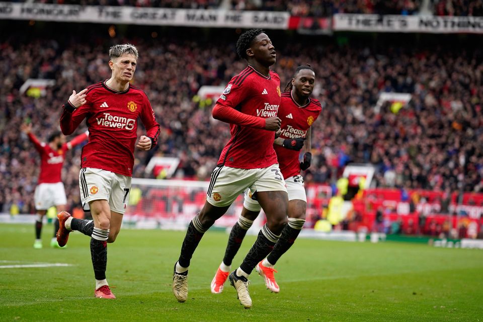 Manchester United's Kobbie Mainoo, centre, celebrates after scoring his side's second goal during the Premier League clash with Liverpool at Old Trafford. Photo: AP Photo/Dave Thompson