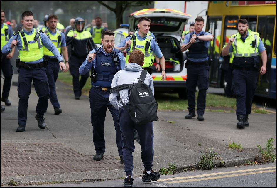 Gardai draw batons during rioting in Coolock. Photo: Steve Humphreys