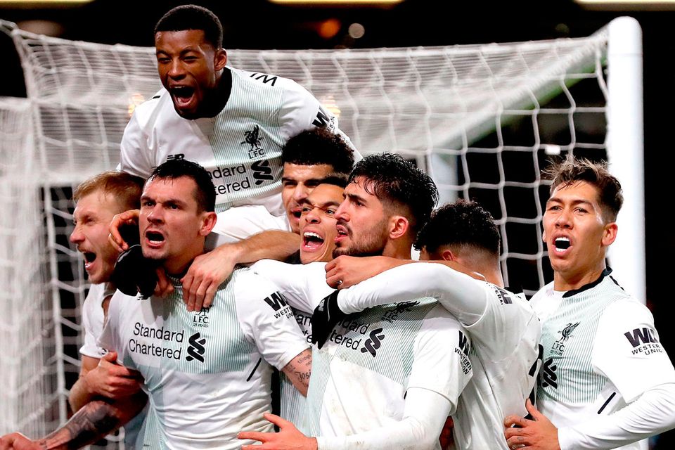 Liverpool's Dejan Lovren (second left) and Liverpool's Emre Can celebrates with team-mates after Liverpool's Ragnar Klavan (left) scores his side's second goal of the game during the Premier League match at Turf Moor, Burnley. Martin Rickett/PA Wire