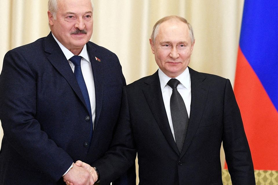 FILE PHOTO: Russian President Vladimir Putin shakes hands with Belarusian President Alexander Lukashenko. Photo: Vladimir Astapkovich/Kremlin via REUTERS.