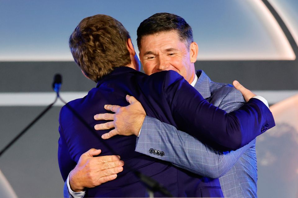 Pádraig Harrington hugs his son Paddy as Pádraig is inducted during the World Golf Hall of Fame Induction at the Carolina Hotel 