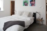 thumbnail: The bedrooms are simply furnished in white and grey. The pictures over the bed are copies of the work of a Chinese dissident artist.