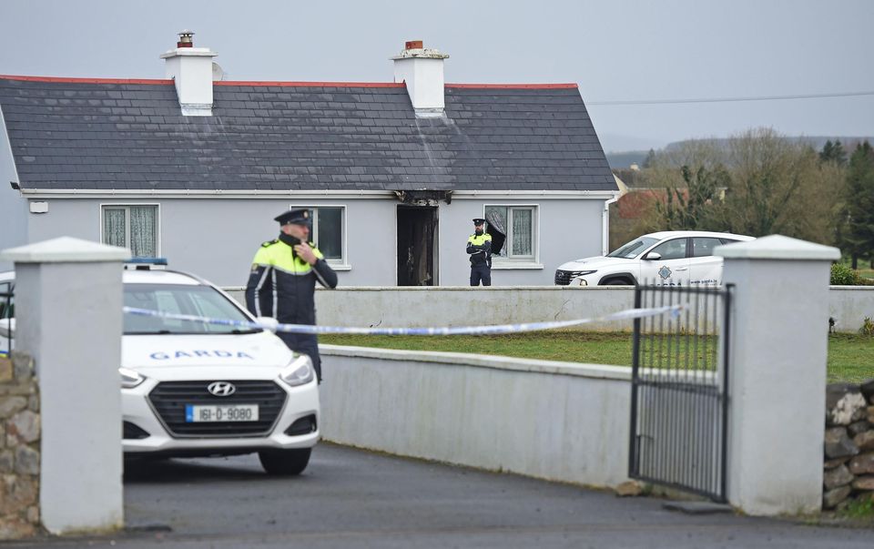 Gardaí attend the scene of the house fire in Pheasanthill, Castlebar, Co Mayo after the discovery of John Brogan's body. Photo: Conor McKeown