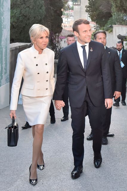 French President Emmanuel Macron and his wife Brigitte arrive for a concert of La Scala Philharmonic Orchestra at the ancient Greek Theatre of Taormina during the Heads of State and of Government G7 summit, on May 26, 2017 in Sicily. / AFP PHOTO / TIZIANA FABI        (Photo credit should read TIZIANA FABI/AFP/Getty Images)