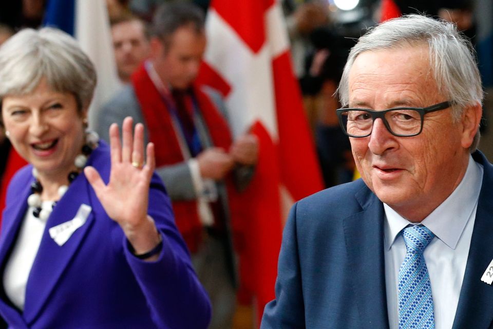 European Commission President Jean-Claude Juncker and Britain’s Prime Minister Theresa May arrive at a European Union leaders’ summit in Brussels yesterday. Photo: Reuters