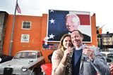 thumbnail: Joe Blewitt, a third cousin of US President Joe Biden, celebrates with his wife Deirdre in front of a mural of the President after his election in November 2020. President Biden's ancestors hail from the Co Mayo town of Ballina. Photo: Charles McQuillan/Getty