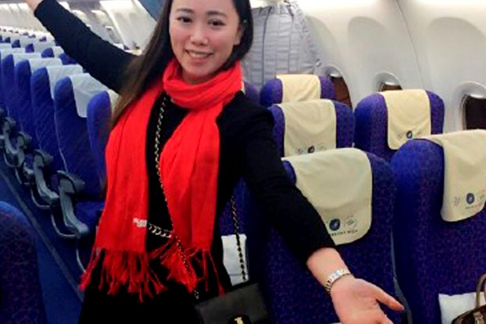 A Chinese woman surnamed Zhang posing for photos on an empty flight from Wuhan to Guangzhou, after the China Southern flight was delayed for 10 hours. Photo: AFP/Getty Images
