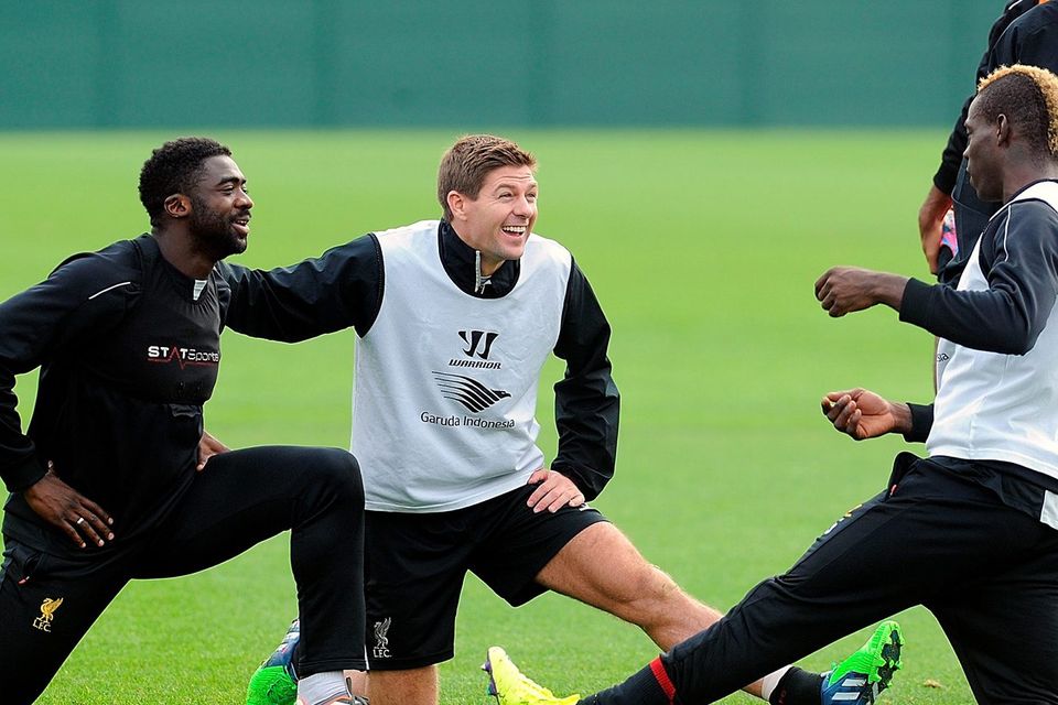 Steven Gerrard talks with Mario Balotelli and Kolo Toure during a training session at Melwood  yesterday. John Powell/Liverpool FC via Getty Images