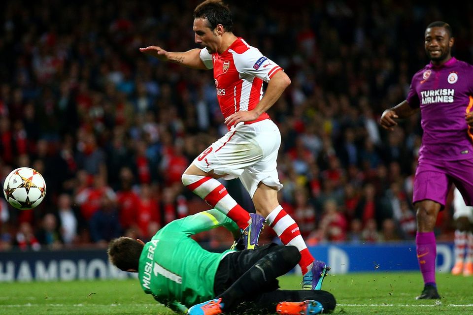 Arsenal's Santi Cazorla chips the ball over Fernando Muslera of Galatasaray, only to see it cleared off the line in the final minute of the Champions League game at the Emirates. Photo: Paul Gilham/Getty Images