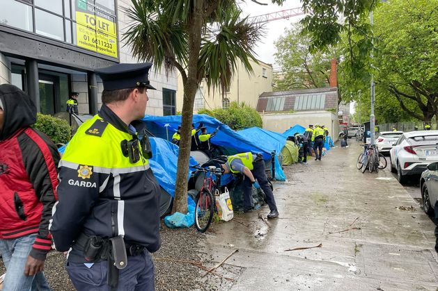 Dublin’s ‘tent city’: Supporters of asylum seekers refuse to move as gardaí dismantle migrant camp