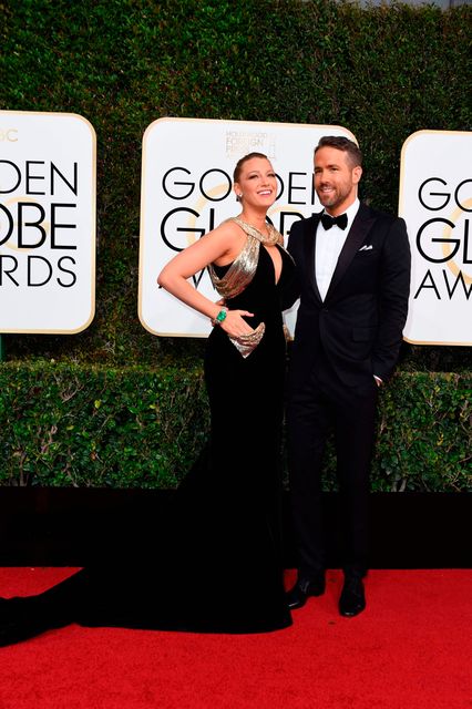 Actress Blake Lively and husband Ryan Reynolds arrive at the 74th annual Golden Globe Awards