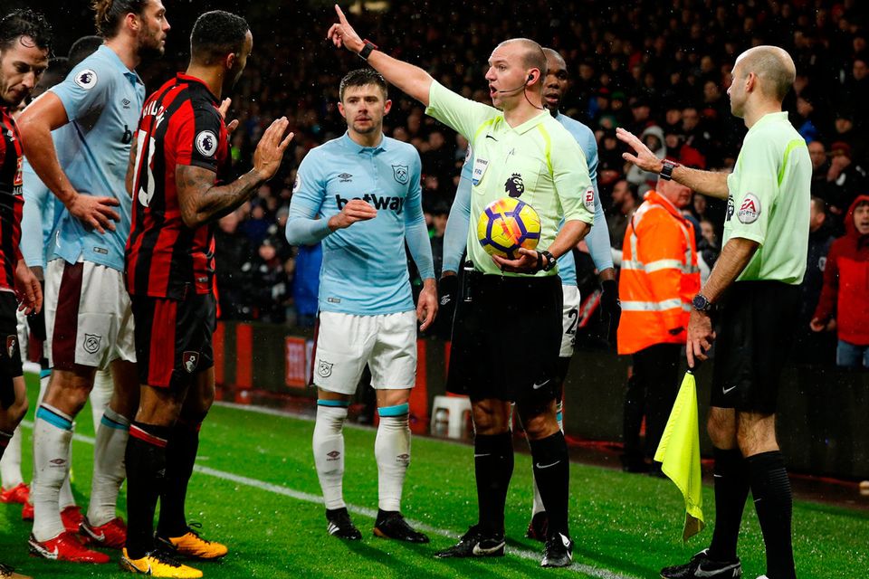 Players surround referee Robert Madley after he makes a decision regarding Bournemouth's late equaliser. Photo: REUTERS/Peter Nicholls