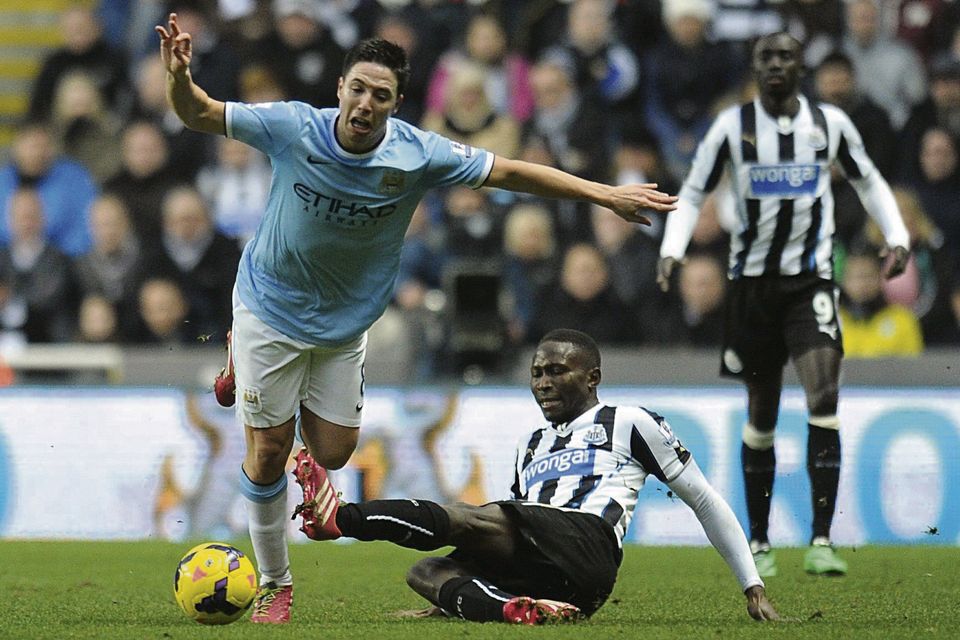 Newcastle's Mapou Yanga-Mbiwa fouls Manchester City's Samir Nasri. Photo: Owen Humphreys/ PA Wire