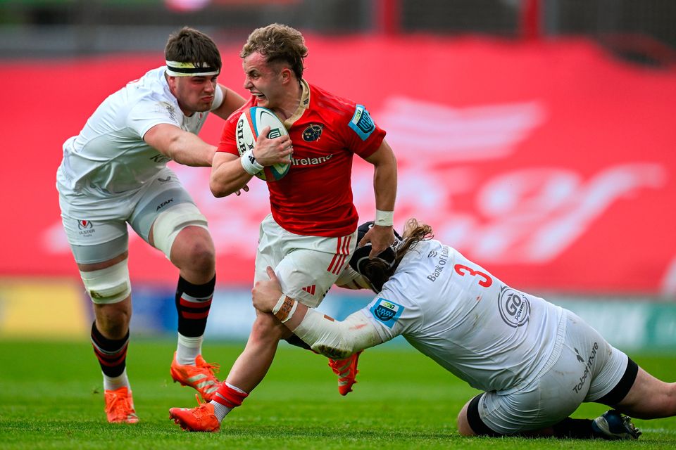 Craig Casey of Munster is tackled by James McNabney and Scott Wilson of Ulster during the United Rugby Championship match at Thomond Park in Limerick. Photo: Brendan Moran/Sportsfile