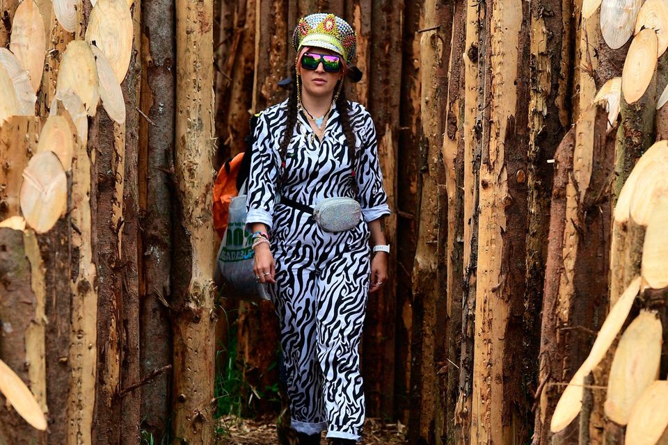 A festival-goer walks among the logs during day one of Glastonbury Festival at Worthy Farm, Pilton on June 26, 2019 in Glastonbury, England.  (Photo by Leon Neal/Getty Images)