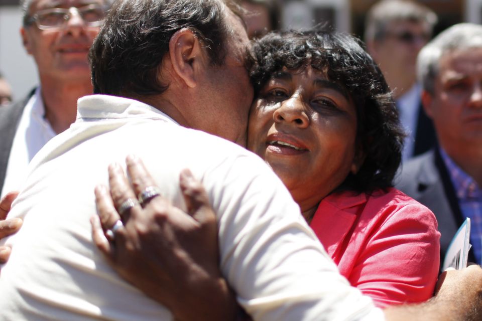 Norma Gomez, sister of fallen soldier Eduardo Gomez, is embraced outside the National Memory Archive after being notified that her brother's remains, buried in an anonymous grave, have been identified, in Buenos Aires, Argentina (AP)