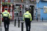 thumbnail: Garda pictured in Temple Bar which is very quiet due to the impact of the Coronavirus